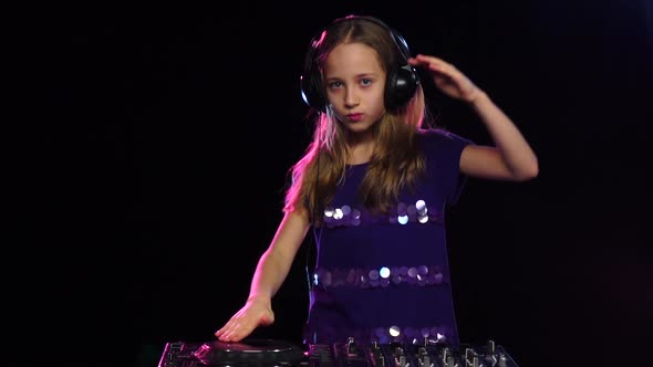 Teen Girl Dj in Headphones Plays for Turntable. Black Background