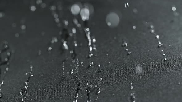 Super Slow Motion Shot of Water Droplets Splashing on Waterproof Cloth at 1000Fps