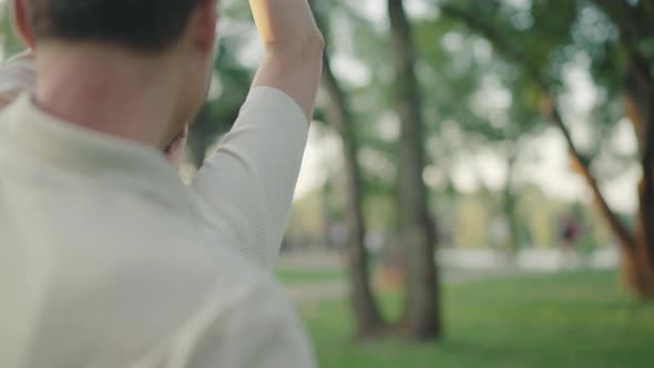 Beautiful Positive Mid-adult Woman Spinning in Sunrays in Summer Park. Portrait of Happy Caucasian