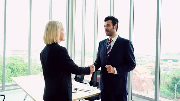 Business People Handshake with Friend at Office