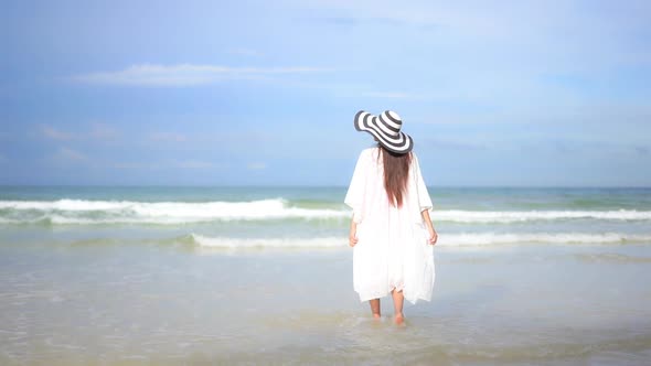 Asian woman enjoy around beautiful beach sea ocean