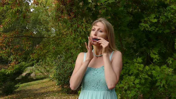 Pretty Blond Woman Playing Harp