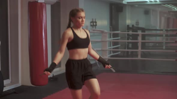 Female Fighter Trains and Jumping Rope Coordination Training Kickboxing Training Day in the Boxing