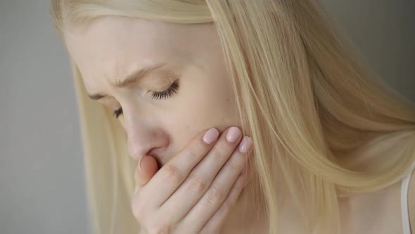 Close Up Of Woman Suffering With Cough