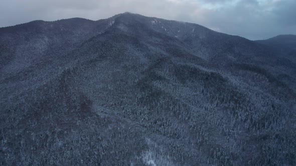 Aerial View of the Mountains Range with Clouds and Storm Clouds in Twilight