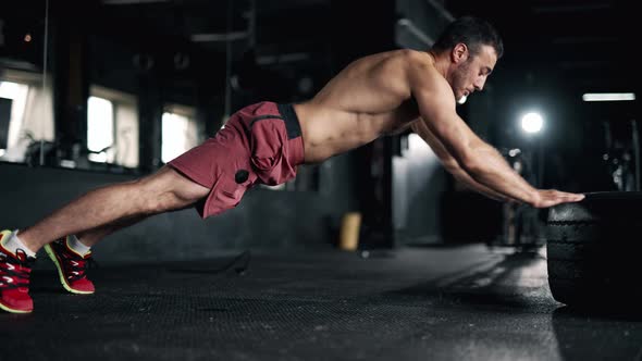 A Handsome Young Muscular Sportsman is Doing Exercise