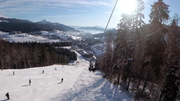 POV From Ski Chair Lift To Snowy Ski Slope, Skiers Slide on Ski Slope.Ski Resort