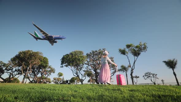 Slow Motion Aircraft Landing at Airport. Traveler Is Welcoming Arriving Airplane