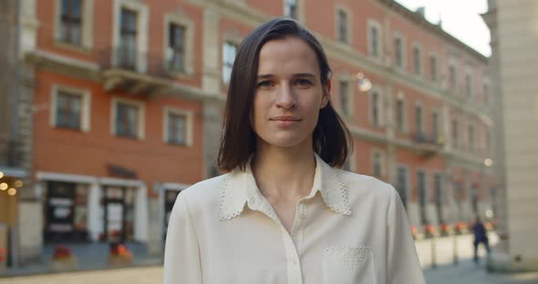 Crop View of Beautiful Young Girl in White Shirt Walking at Old European City Street. Portrait of