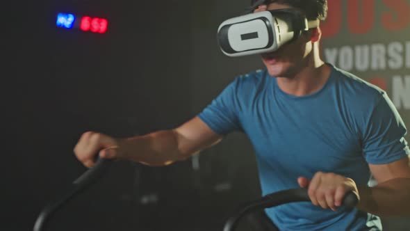 Asian young male practice working out to maintaining muscle in gym or fitness club using VR fitness.