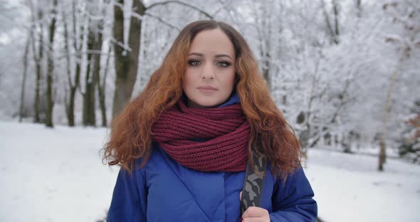 Young Girl Walks In A Snowy Park