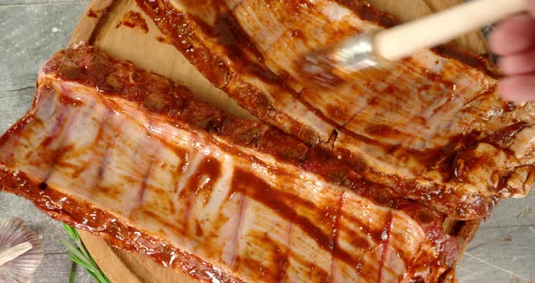 The Men's Hand Marinates in Raw Rib Sauce.