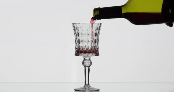 Rose Wine. Red Wine Pour in Wine Glass Over White Background