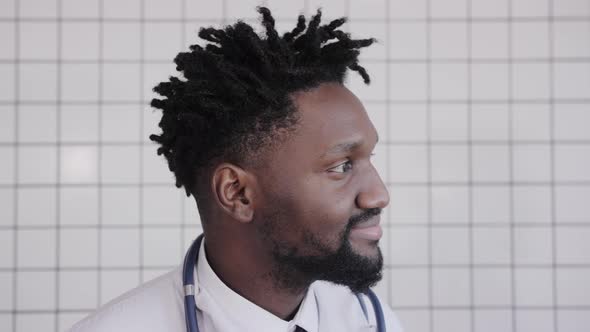 Closeup Portrait of Black Doctor Smiling and Looking at Camera