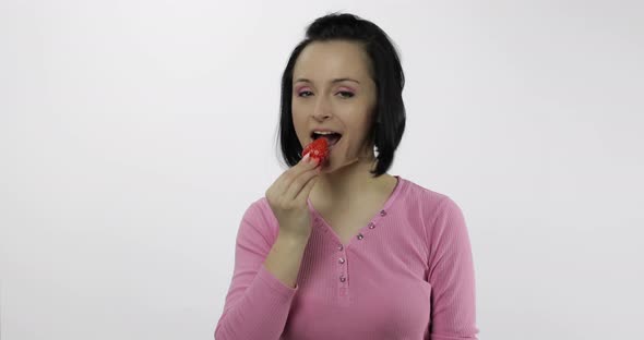 Woman Eating Strawberry and Says Yum. Girl Takes First Bite and Say Wanna Bite