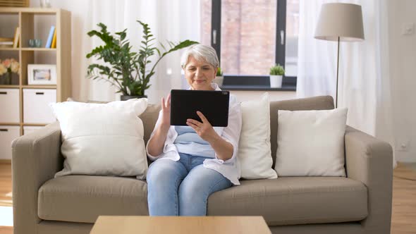 Senior Woman Having Video Chat on Tablet Pc 