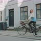 Attractive woman standing with her bicycle in the city - VideoHive Item for Sale