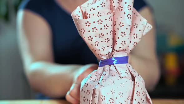 Close-up of a Woman's Hand Packing a Gift