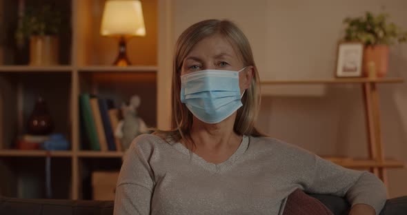 Crop View of Mature Woman in Medical Protective Mask Turning Head and Looking To Camera