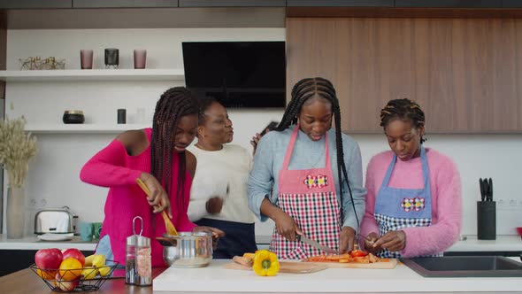 Happy Proud Black Mom Filming on Phone Cooking Daughters