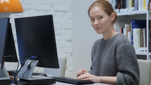 Thumbs Up Gesture  by Redhead Woman in Office