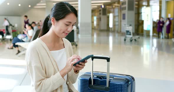 Woman use of mobile phone in airport