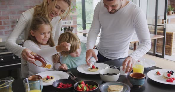 Family garnishing food at dining table in a comfortable home 4k