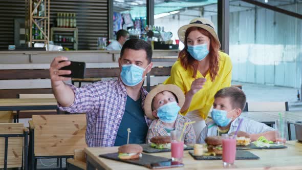 Quarantine Celebration, Happy Joyful Family in Medical Masks for Protection Against Virus and