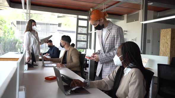 Diverse female colleagues working in office together