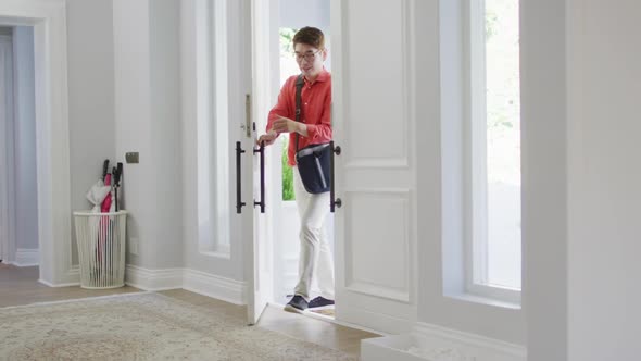 Excited asian son at home running to greet his father coming through the front door