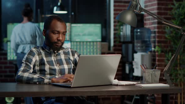 Sales Trader Working on Stock Market Economy with Laptop