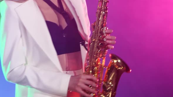 Young Sexy, Blonde Woman Dj in White Jacket and Black Top Playing Music Using Saxophone, Dancing