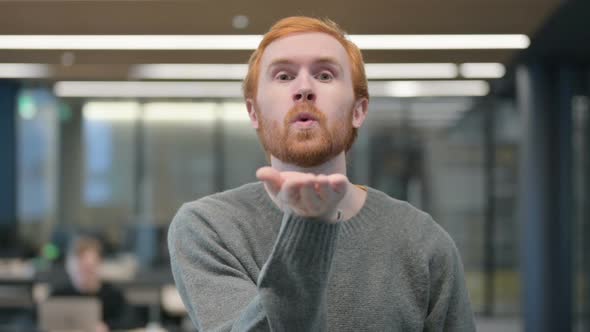 Portrait of Young Man Giving Flying Kiss