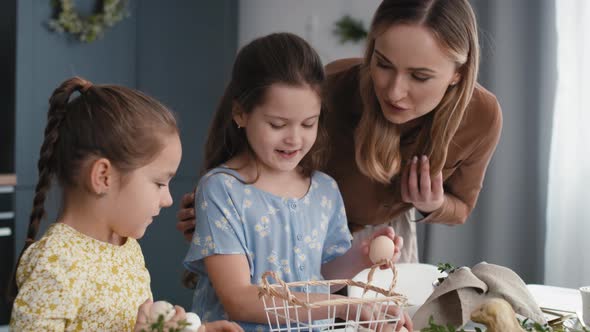 Caucasian mother and daughters during Easter time arranging eggs. Shot with RED helium camera in 8K.