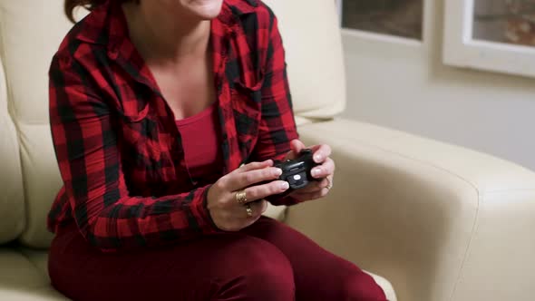 Single Woman Sitting on Sofa Playing Video Games