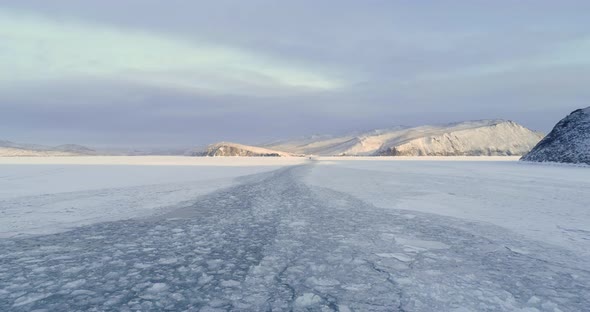 Majestic Snow Winter Ice Landscape. Snow Covered Surface of lake Baikal. Aerial View Flight