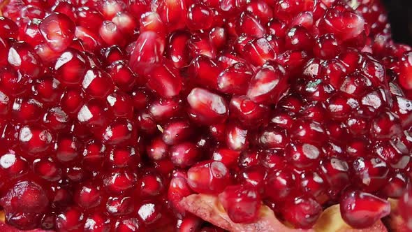 Red Pomegranate Grains Bouncing on Other Grains