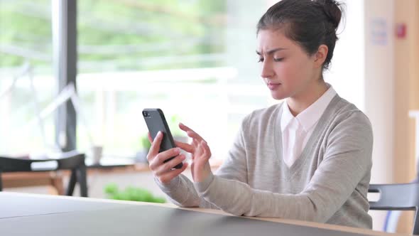 Disappointed Indian Woman Having Loss on Smartphone