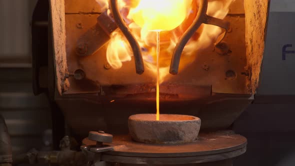 The Molten Metal is Poured Into the Smelter Bowl at the Plant for Production Items Out of Silver