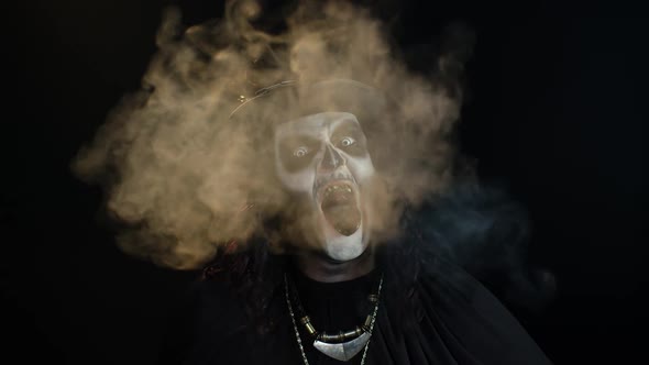 Frightening Man in Skeleton Halloween Makeup Screaming, Shouting, Exhaling Cigarette Smoke