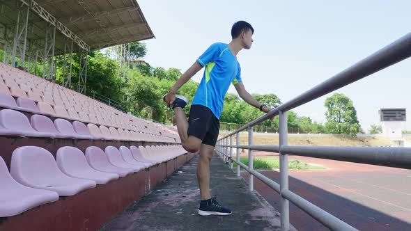 Man Athlete In Sportswear Doing Warm-Up At The Stadium