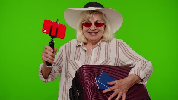 Mature Woman Traveler Blogger in Sunglasses Taking Selfie Portrait Photo Video Call on Smartphone