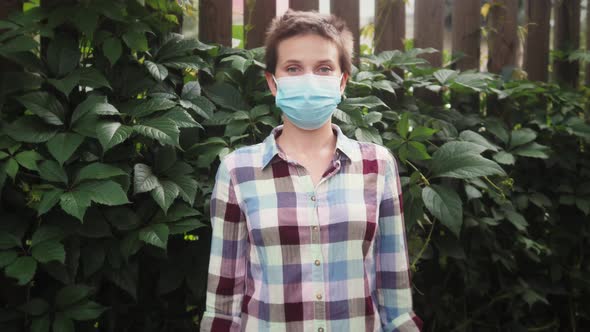 Portrait of Farmer Worker in Protective Medical Mask and Gloves Posing on Camera with Crossed Arms