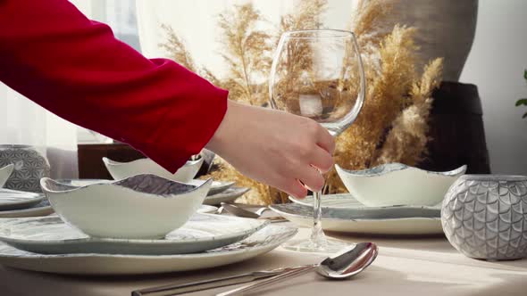 Close Up of Woman Setting Table