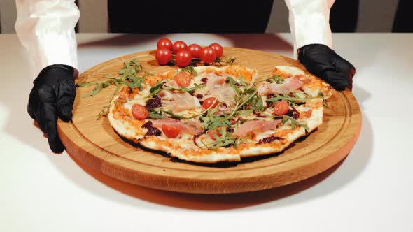 The Finished Dish is Homemade Pizza with Tomatoes Prosciutto and Green Arugula Leaves That the