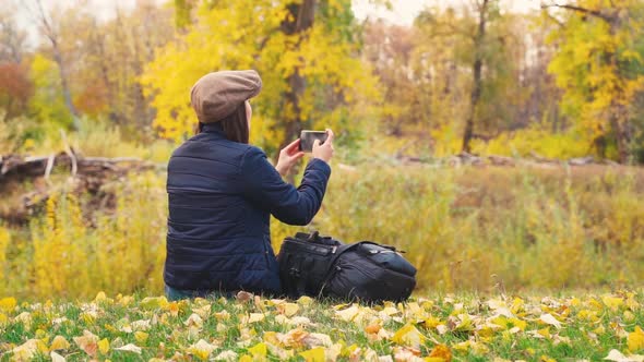 Girl Tourist on a Hike in the Autumn Forest