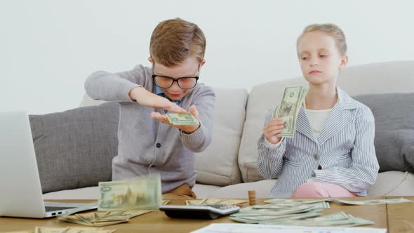 Kids as business executive throwing money 4k