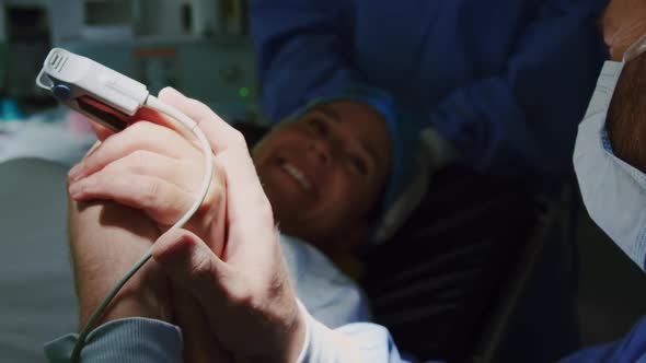 Close-up of Caucasian man comforting pregnant woman during labor in operation theater 