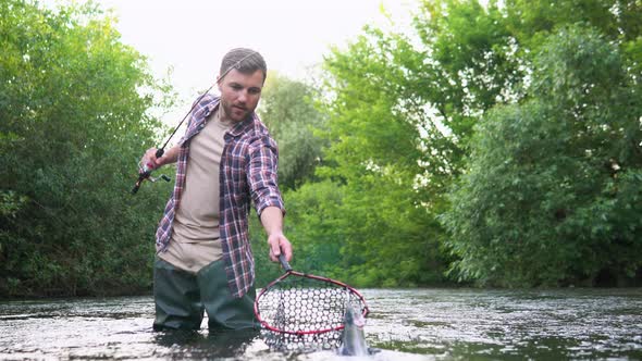 Fisherman with Fishing Rod on the River