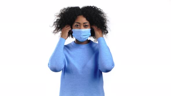 Pleased Mixed Race Woman Removed Protective Mask and Throws It on Floor As Symbol of Pandemic